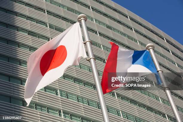 Japanese and French flags at the Nissan Motor Co., Ltd. Global Headquarters in Kanagawa.