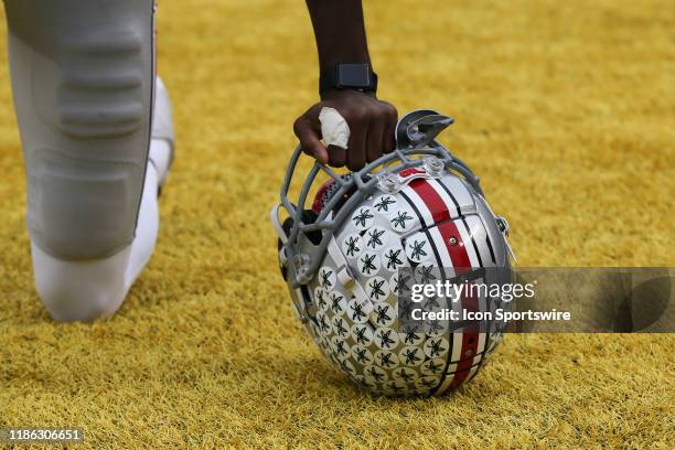 An Ohio State player is seen kneeling in the end zone with his helmet before the start a regular season Big 10 Conference game between the Ohio State...