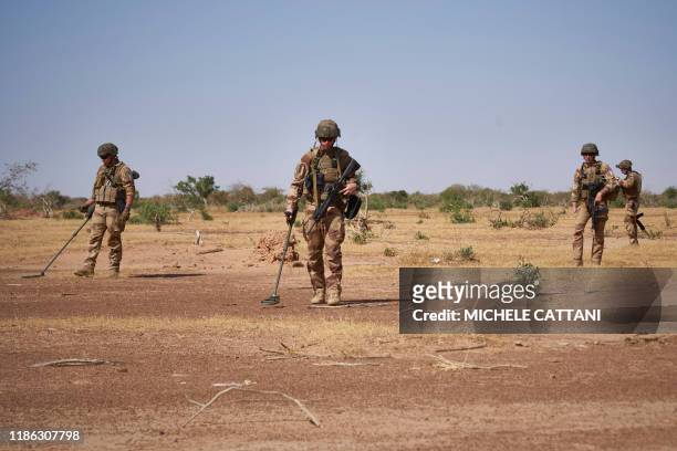 Soldiers from the French Army holds detectors while searching for the presence of IED during the Burkhane Operation in northern Burkina Faso on...