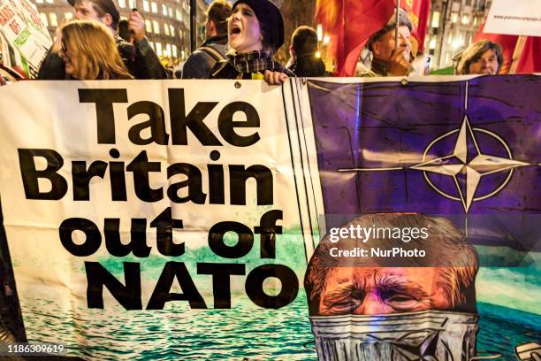 Protester shouts holding an anti-Trump banner in a demonstration against 70th Anniversary NATO Summit celebrated in London.