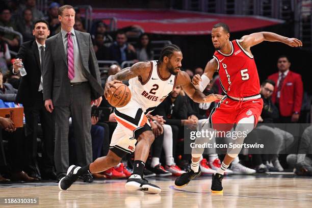 Los Angeles Clippers Forward Kawhi Leonard drives as he is defended closely by Portland Trail Blazers Forward Rodney Hood during a NBA game between...