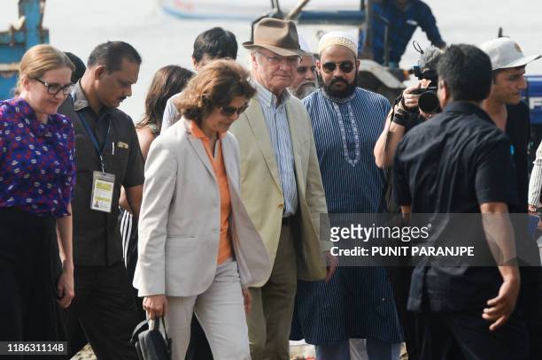 Sweden's King Carl XVI Gustaf and Queen Silvia arrive to participate in a beach clean-up project a the Versova Beach in Mumbai on December 4, 2019.