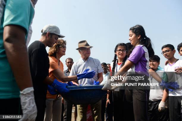 Sweden's King Carl XVI Gustaf and Queen Silvia participate in a beach clean-up project a the Versova Beach in Mumbai on December 4, 2019.