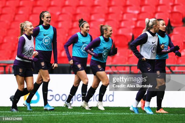 England players warm up for their training session on the eve of the Women's International Friendly between England and Germany at Wembley Stadium on...
