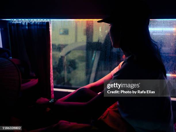 woman looking through glass in the night - hanoi night stockfoto's en -beelden