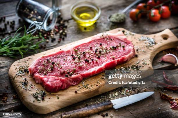 raw fillet steak shot on rustic wooden table - fillet steak stock pictures, royalty-free photos & images