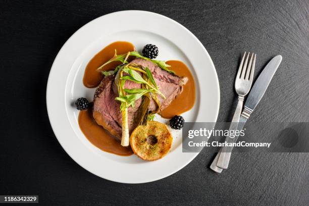 venison with apple and seasonal vegetables. - food plate stock pictures, royalty-free photos & images