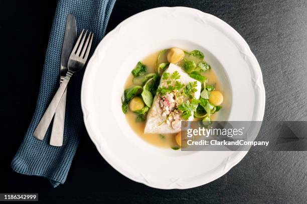 cod fillet with beurre blanc sauce and apple. - serving dish stock pictures, royalty-free photos & images
