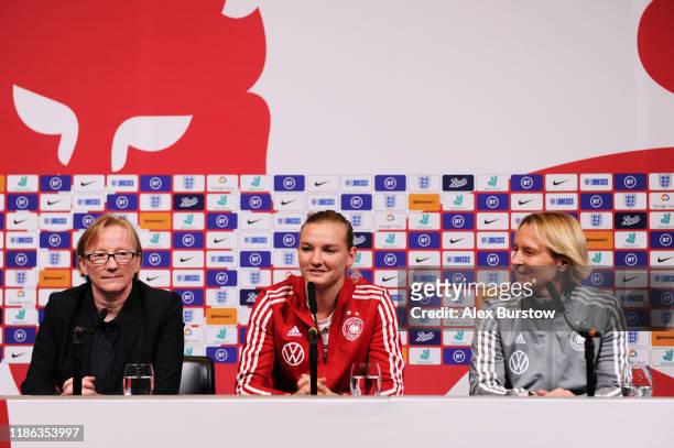 Alexandra Popp of Germany speaks to the media as Martina Voss-Tecklenburg, Head Coach of Germany looks on during a press conference on the eve of the...