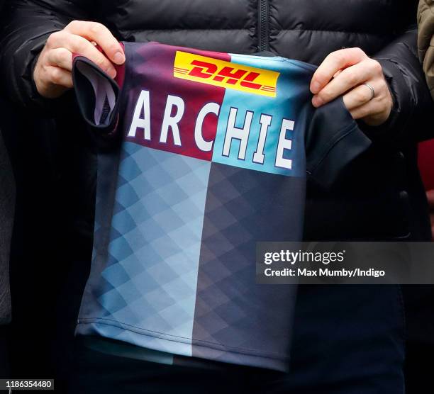 Prince Harry, Duke of Sussex is presented with a Harlequins rugby shirt for his baby son Archie Harrison Mountbatten-Windsor as he attends a Terrence...