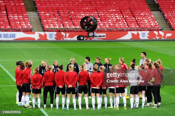 Martina Voss-Tecklenburg, Head Coach of Germany speaks to her team as they huddle on the pitch prior to their training session on the eve of the...