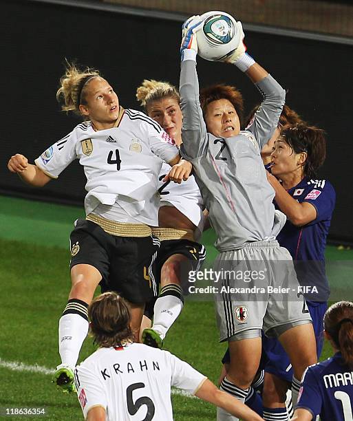 Goalkeeper Ayumi Kaihori of Japan saves a ball against Babett Peter and Bianca Schmidt during the FIFA Women's World Cup quarter finals match between...