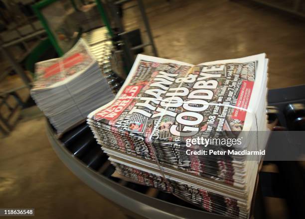 Copies of the last-ever News of The World newspaper are carried on a conveyor belt at the Newsprinters plant on July 9, 2011 in Waltham Cross,...