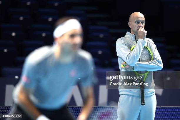 Ivan Ljubicic watches Roger Federer of Switzerland in a practice session during previews for the Nitto ATP Finals at The O2 Arena on November 08,...