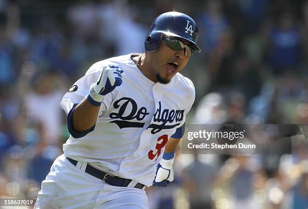 Dioner Navarro of the Los Angeles Dodgers celebrates as he runs to first on his walk off RBI single with two outs n the ninth inning against the San...