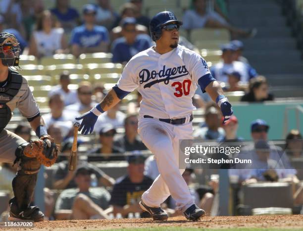 Dioner Navarro of the Los Angeles Dodgers hits a walk off RBI single with two outs n the ninth inning against the San Diego Padres on July 9, 2011 at...