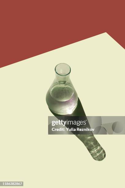 top view of beaker on the yellow-brown background - bottles glass top stockfoto's en -beelden