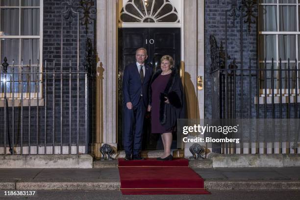 Erna Solberg, Norway's prime minister, right, and her husband Sindre Finnes, arrive to attend a reception to mark the 70th anniversary of the forming...
