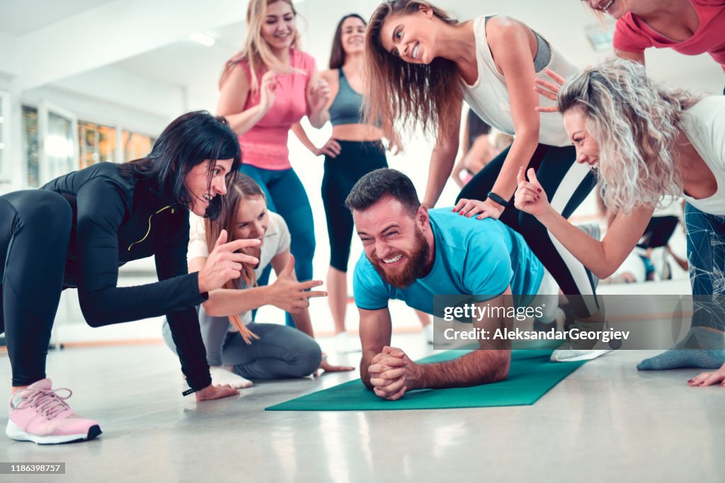 Female Athletes Bullying Young Male Athlete In Gym