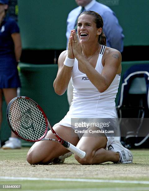 Amelie Mauresmo falls to the ground after winning the Ladies' championship by defeating Justine Henin-Hardenne in the 2006 Wimbledon Championships at...