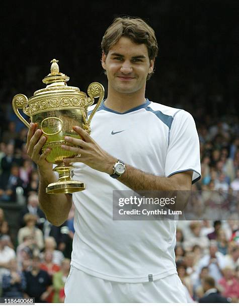 Roger Federer raises the championship trophy after defeating Andy Roddick in the Gentlemen's singles final at Wimbledon, London, July 3, 2005....