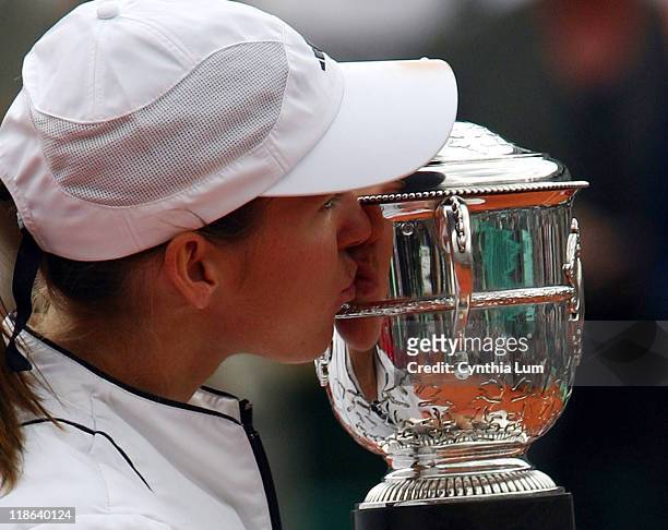 Justine Henin-Hardenne kisses the winner's trophy after the French Open final. Henin-Hardenne defeated Mary Pierce 6-1, 6-1 at Roland Garros Stadium,...