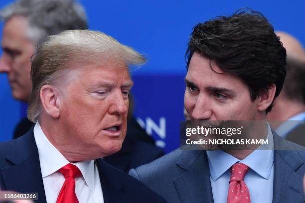 President Donald Trump talks with Canada's Prime Minister Justin Trudeau during the plenary session of the NATO summit at the Grove hotel in Watford,...