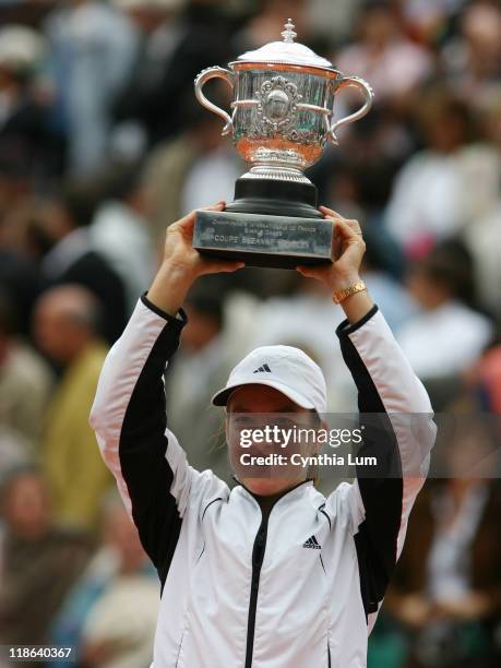 Justine Henin-Hardenne raises the winner's trophy after the French Open final. Henin-Hardenne defeated Mary Pierce 6-1, 6-1 at Roland Garros Stadium,...