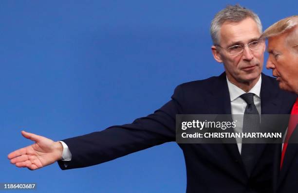 Secretary General Jens Stoltenberg welcomes US President Donald Trump upon his arrival for the NATO summit at the Grove hotel in Watford, northeast...