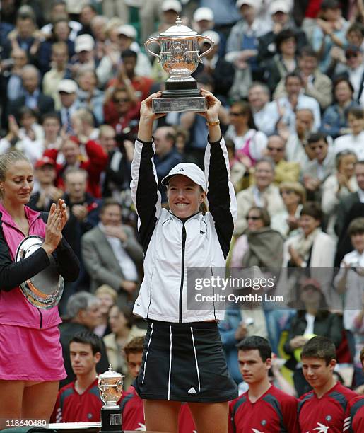 Justine Henin-Hardenne raises the winner's trophy after the French Open final. Henin-Hardenne defeated Mary Pierce 6-1, 6-1 at Roland Garros Stadium,...