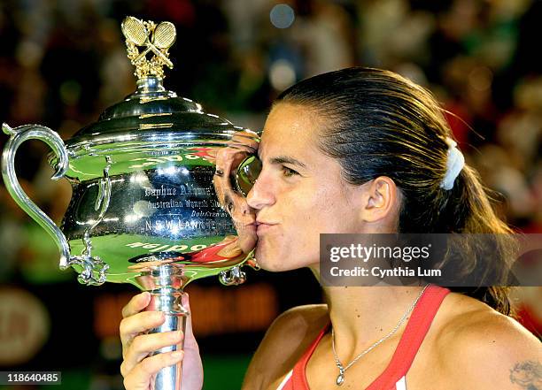 Amelie Mauresmo kisses the trophy after beating Justine Henin-Hardenne in the women's singles final at the 2006 Australian Open at Melbourne Park in...