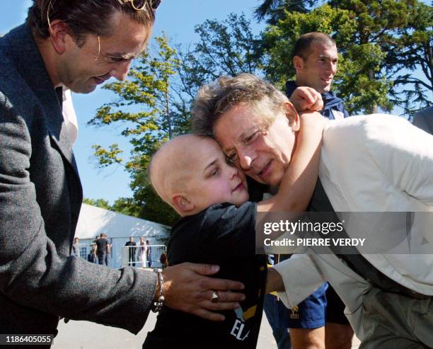 Le réalisateur français d'origine polonaise Roman Polanski embrasse Antoine , 10 ans, sous l'oeil de son père et du meneur de jeu de l'équipe de...