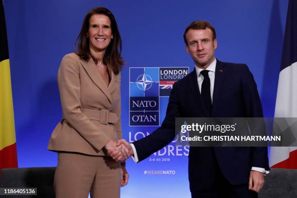 France's President Emmanuel Macron and Belgium's Prime Minister Sophie Wilmes shake hands as they hold a news conference during the NATO summit at...