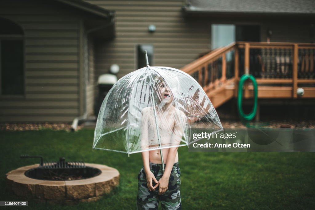 Boy with clear umbrella
