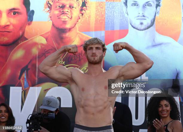 Logan Paul flexes his muscles after the official weigh-in at L.A. Live Xbox Plaza on November 08, 2019 in Los Angeles, California.