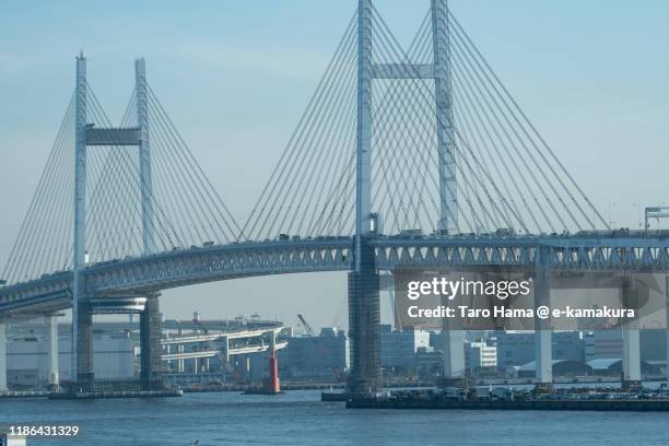 yokohama bay bridge and port of yokohama in kanagawa prefecture of japan - yokohama brücke stock-fotos und bilder