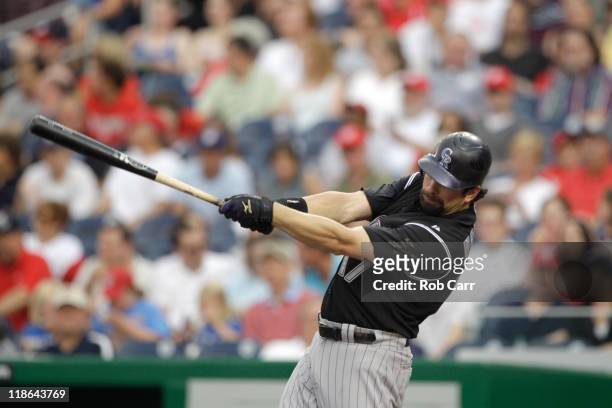Todd Helton of the Colorado Rockies follows his solo home run against the Washington Nationals during the fourth inning at Nationals Park on July 9,...