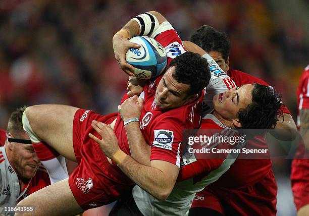 Jono Lance of the Reds is tackled during the 2011 Super Rugby Grand Final match between the Reds and the Crusaders at Suncorp Stadium on July 9, 2011...