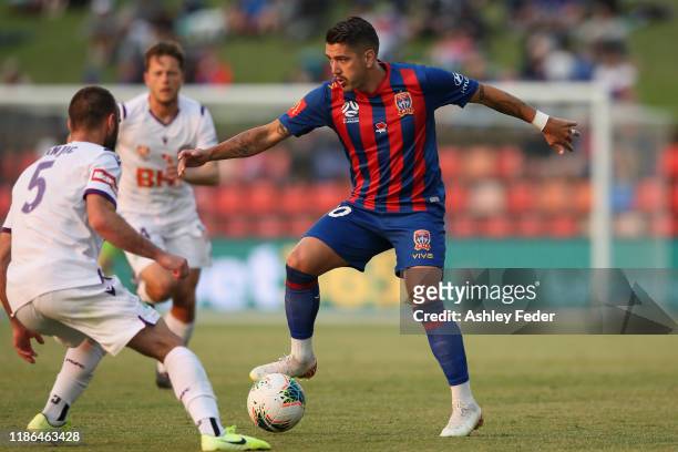 Dimitri Petratos of the Newcastle Jets is contested by Ivan Franjic of Perth Glory during the Round 5 A-League match between the Newcastle Jets and...