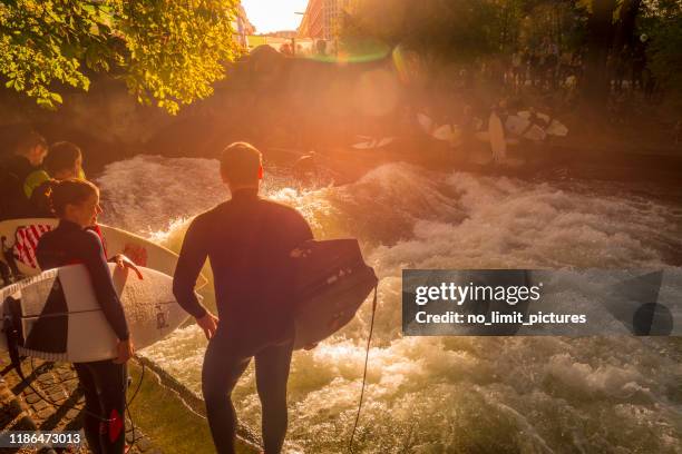 surfer at the eisbach river in munich - munich surfing stock pictures, royalty-free photos & images