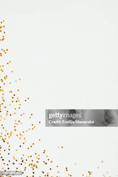 glittery yellow star confetti on white background - star confetti white background stockfoto's en -beelden