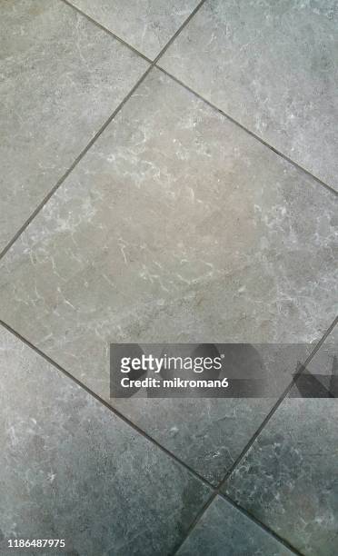 personal view of tiled floor - hochglanz stock-fotos und bilder