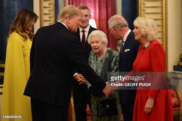 Britain's Queen Elizabeth II speaks with US First Lady Melania Trump and US President Donald Trump , Britain's Camilla, Duchess of Cornwall and...