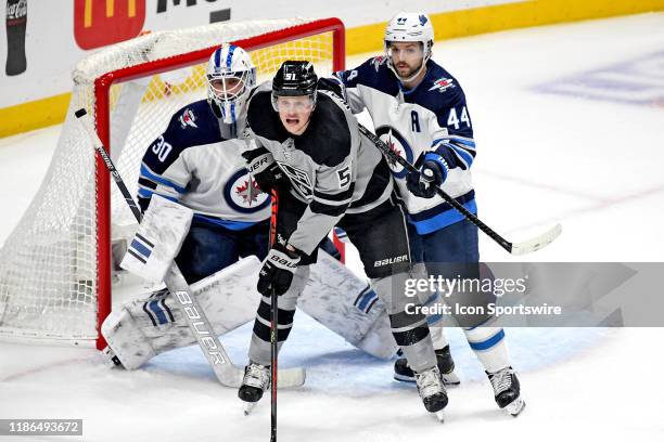 Los Angeles Kings Right Wing Austin Wagner battles for position in front of Winnipeg Jets Defenceman Josh Morrissey and Goalie Laurent Brossoit...