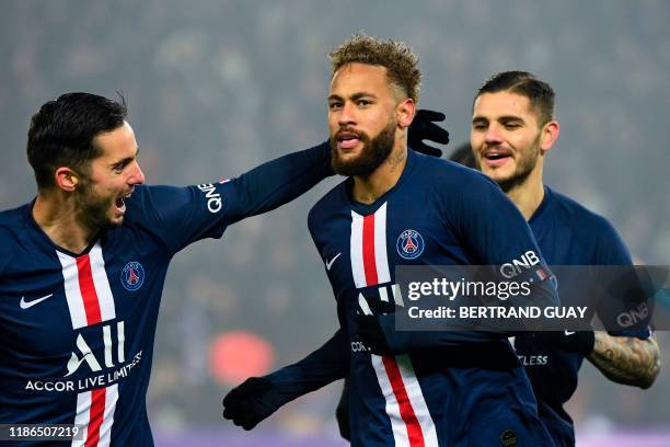 Paris Saint-Germain's Brazilian forward Neymar is congratulated by teammates after scoring a goal during the French L1 football match between Paris...