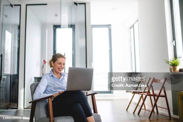 mature caucasian woman using laptop in the office - online workshop stock pictures, royalty-free photos & images