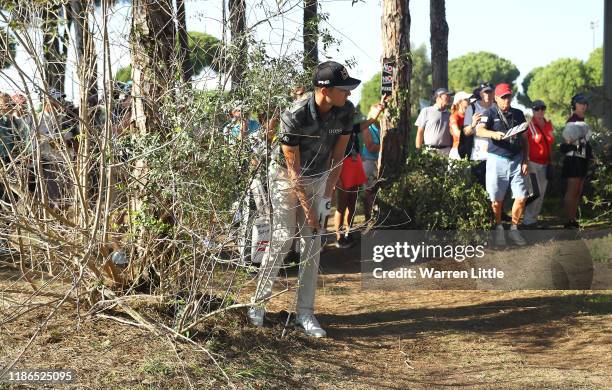 Matthias Schwab of Austria plays from a bush on the 12th hole during the third round of the Turkish Airlines Open at The Montgomerie Maxx Royal on...