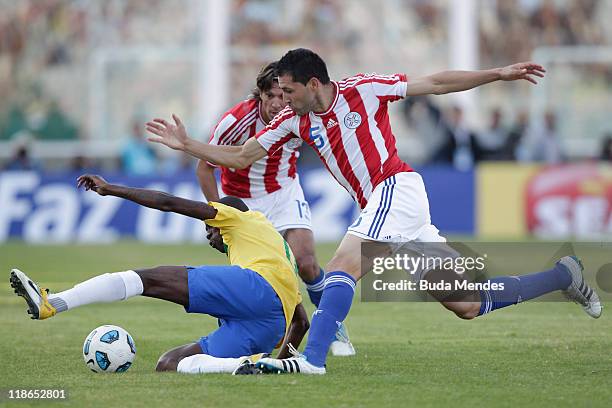 Ramirez of Brazil struggles for the ball with Antolin Alcaraz of Paraguay during a match as part of Group B of Copa America 2011 at the Mario Kempes...