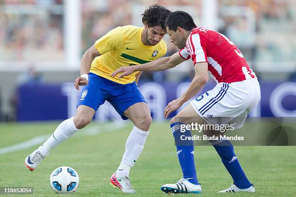 Alexandre Pato of Brazil struggles for the ball with Antolin Alcaraz of Paraguay during a match as part of Group B of Copa America 2011 at the Mario...