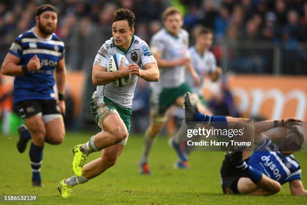 Tom Collins of Northampton Saints looks to break past the tackle from Rhys Priestland of Bath Rugby during the Gallagher Premiership Rugby match...